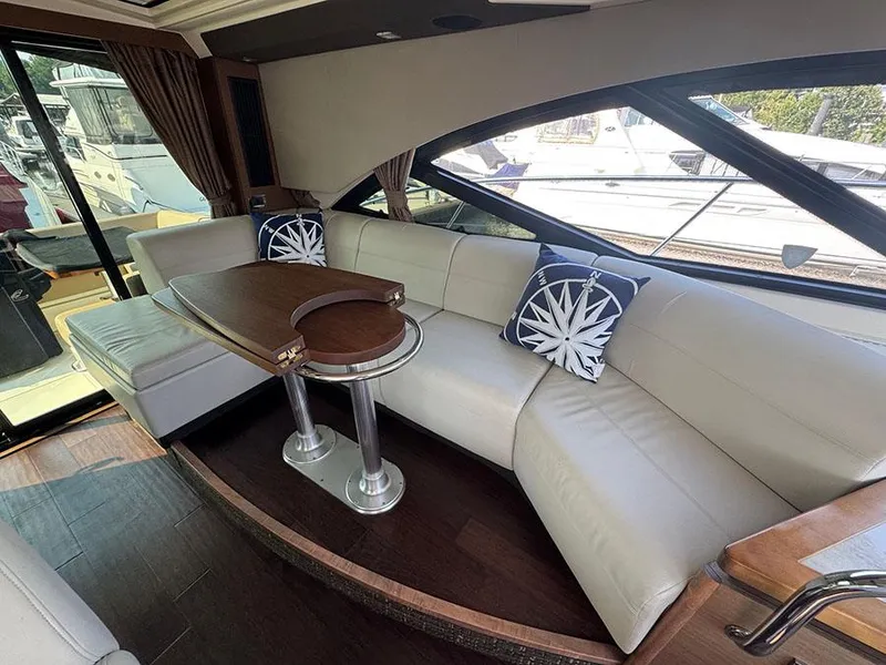 Slide: The Image of Luxurious interior of 2015 Sea Ray 510 Sundancer yacht with elegant seating and table. - 11