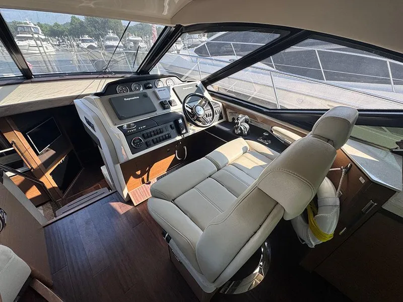 Slide: The Image of Luxurious 2015 Sea Ray 510 Sundancer helm with modern controls and plush seating. - 12
