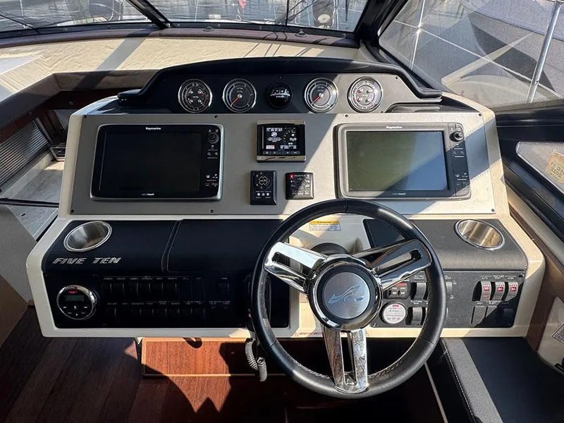 Slide: The Image of Helm of 2015 Sea Ray 510 Sundancer with modern navigation controls and steering wheel. - 14
