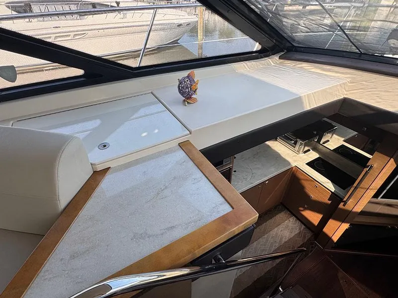 Slide: The Image of Interior of 2015 Sea Ray 510 Sundancer yacht with modern kitchen and seating area. - 18