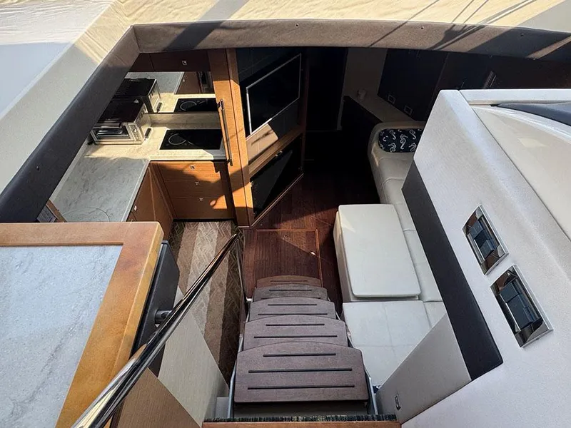 Slide: The Image of Interior of 2015 Sea Ray 510 Sundancer yacht, featuring modern kitchen and seating area. - 20