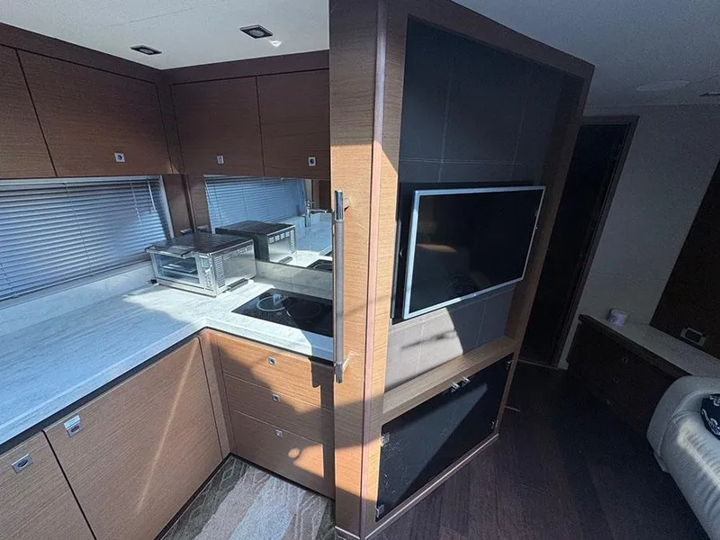 Slide: The Image of Luxurious interior of 2015 Sea Ray 510 Sundancer yacht with modern kitchen and entertainment area. - 22