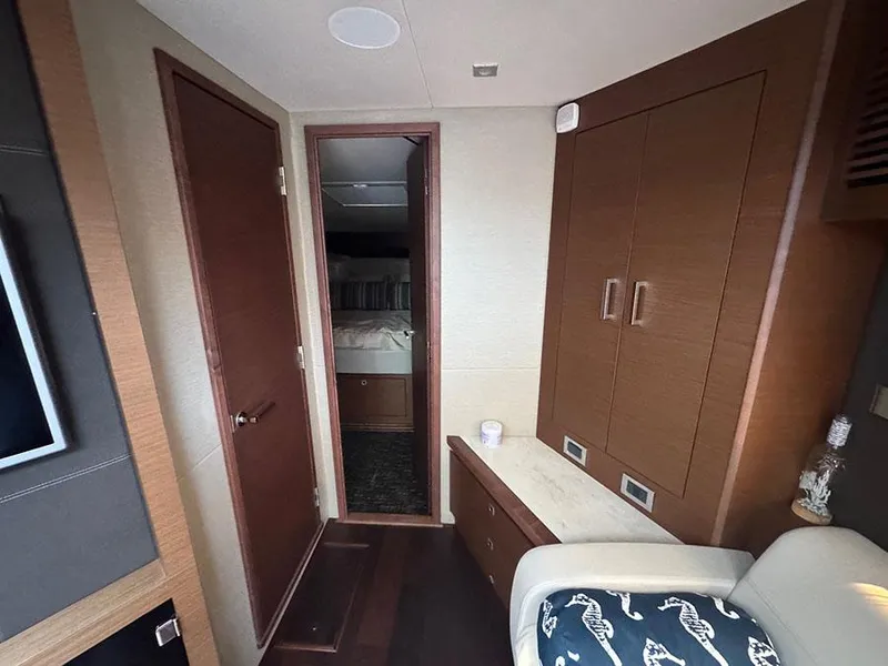 Slide: The Image of Interior of 2015 Sea Ray 510 Sundancer yacht, featuring wood cabinetry and cozy seating. - 23