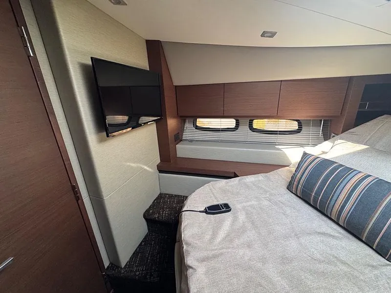 Slide: The Image of Luxurious interior of 2015 Sea Ray 510 Sundancer yacht with TV and comfortable bedding. - 27
