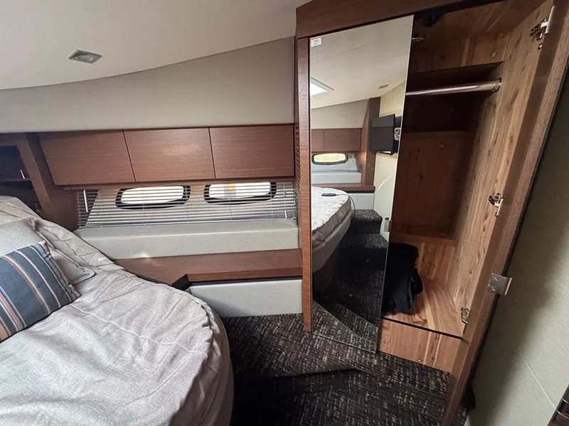 Slide: The Image of Luxurious cabin interior of 2015 Sea Ray 510 Sundancer yacht with bed and closet. - 28