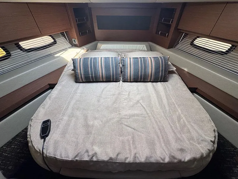 Slide: The Image of Luxurious cabin interior of 2015 Sea Ray 510 Sundancer yacht with cozy bed and striped pillows. - 29