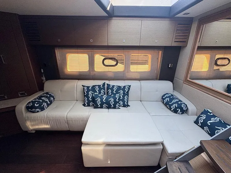 Slide: The Image of Luxurious interior of 2015 Sea Ray 510 Sundancer with white leather seating and seahorse-patterned cushions. - 30