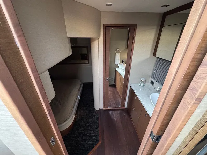 Slide: The Image of 2015 Sea Ray 510 Sundancer interior with bedroom and bathroom, featuring modern design and wood finishes. - 32