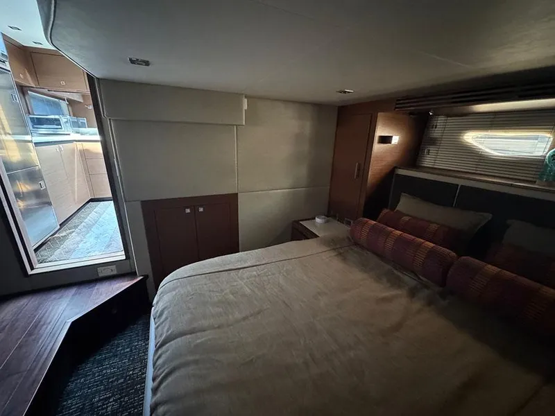 Slide: The Image of Luxurious cabin interior of 2015 Sea Ray 510 Sundancer yacht, featuring cozy bed and modern design. - 37