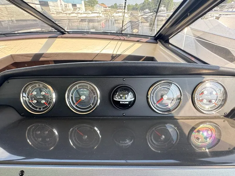 Slide: The Image of Dashboard of 2015 Sea Ray 510 Sundancer with gauges and compass. - 43