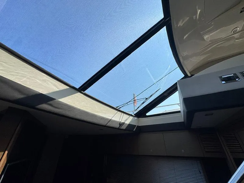 Slide: The Image of Interior view of 2015 Sea Ray 510 Sundancer with sunroof and clear blue sky. - 44