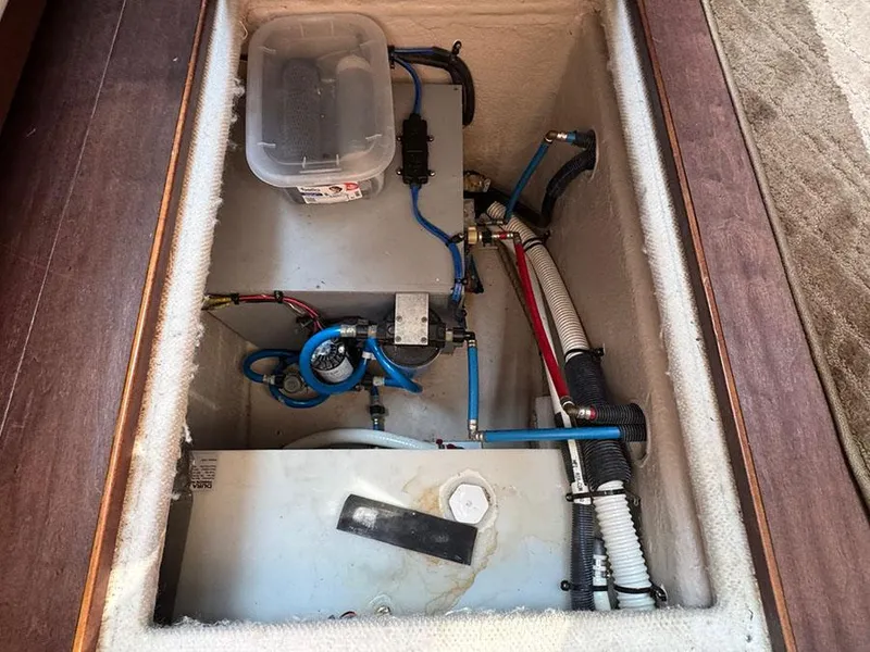 Slide: The Image of Engine compartment of a 2015 Sea Ray 510 Sundancer with visible wiring and components. - 45