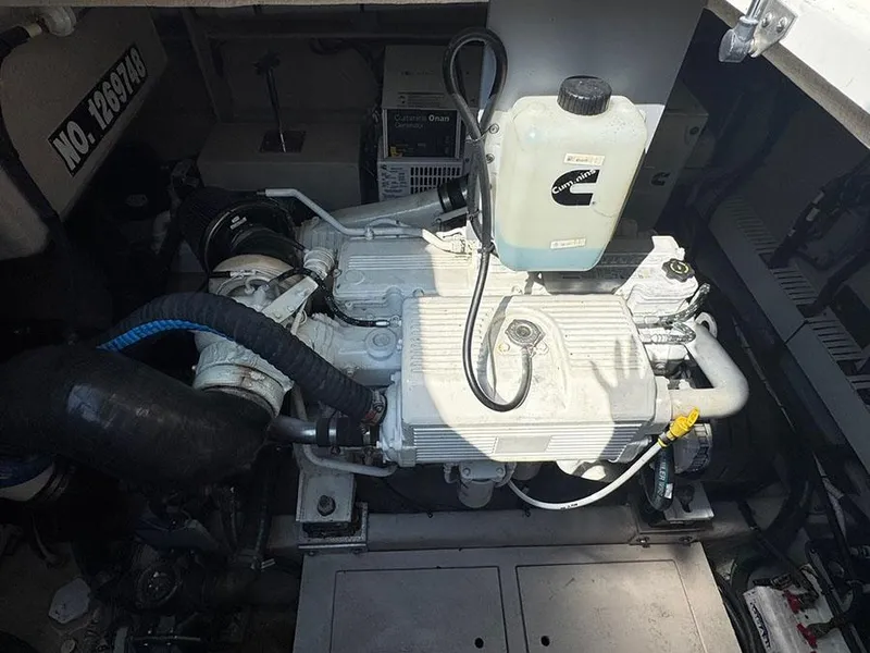 Slide: The Image of Engine compartment of a 2015 Sea Ray 510 Sundancer boat, featuring mechanical components. - 47