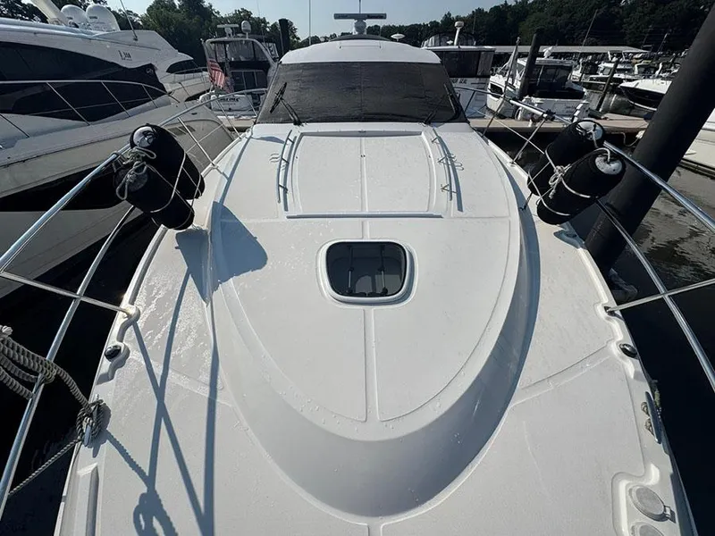 Slide: The Image of 2015 Sea Ray 510 Sundancer yacht docked, showcasing sleek deck design and modern features. - 7