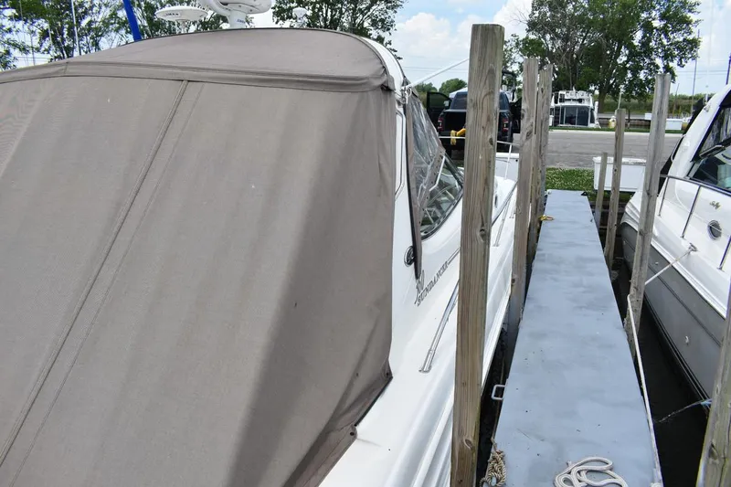 Slide: The Image of 2003 Sea Ray 360 Sundancer docked with protective cover, side view. - 13