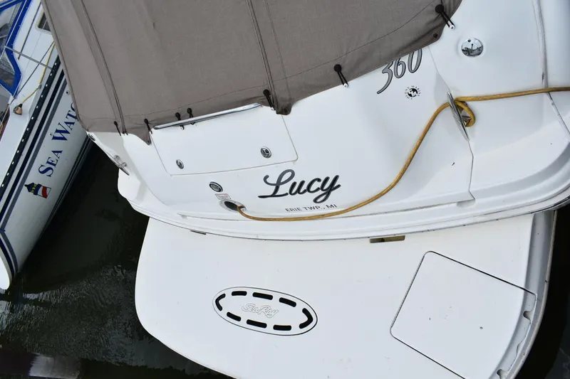 Slide: The Image of 2003 Sea Ray 360 Sundancer named "Lucy" docked beside another boat. - 15