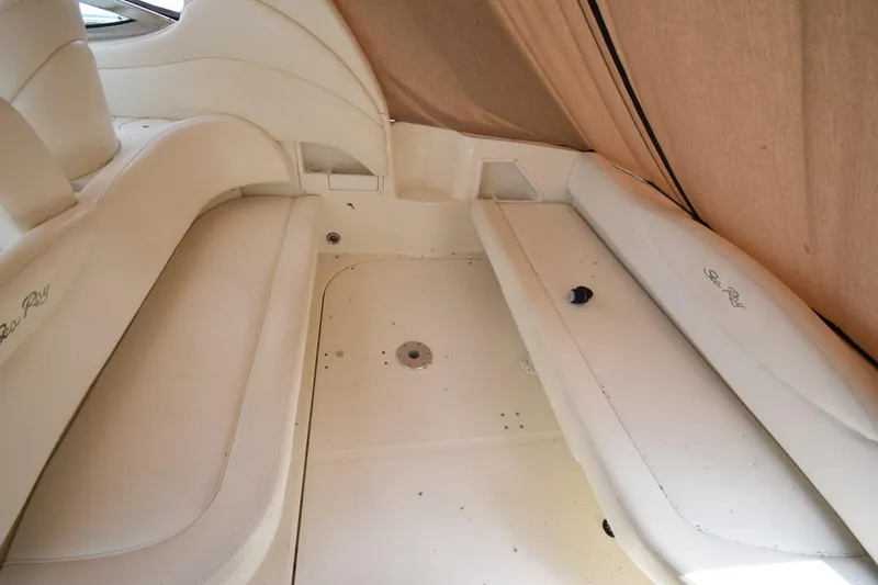 Slide: The Image of 2003 Sea Ray 360 Sundancer interior with beige seating and covered area. - 17