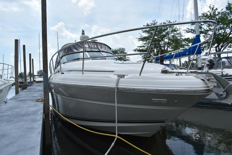 Slide: The Image of 2003 Sea Ray 360 Sundancer docked at marina, side view. - 2
