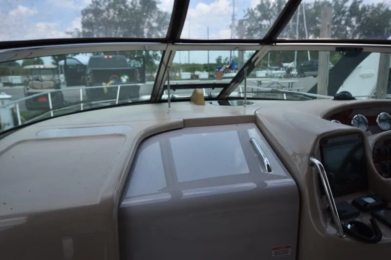 Slide: The Image of 2003 Sea Ray 360 Sundancer helm with windshield and dashboard view. - 21