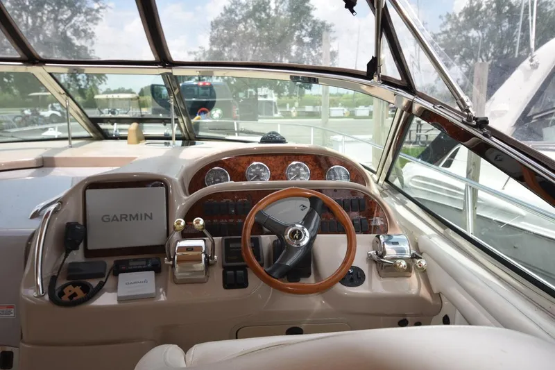 Slide: The Image of 2003 Sea Ray 360 Sundancer helm with Garmin navigation system and wooden steering wheel. - 23