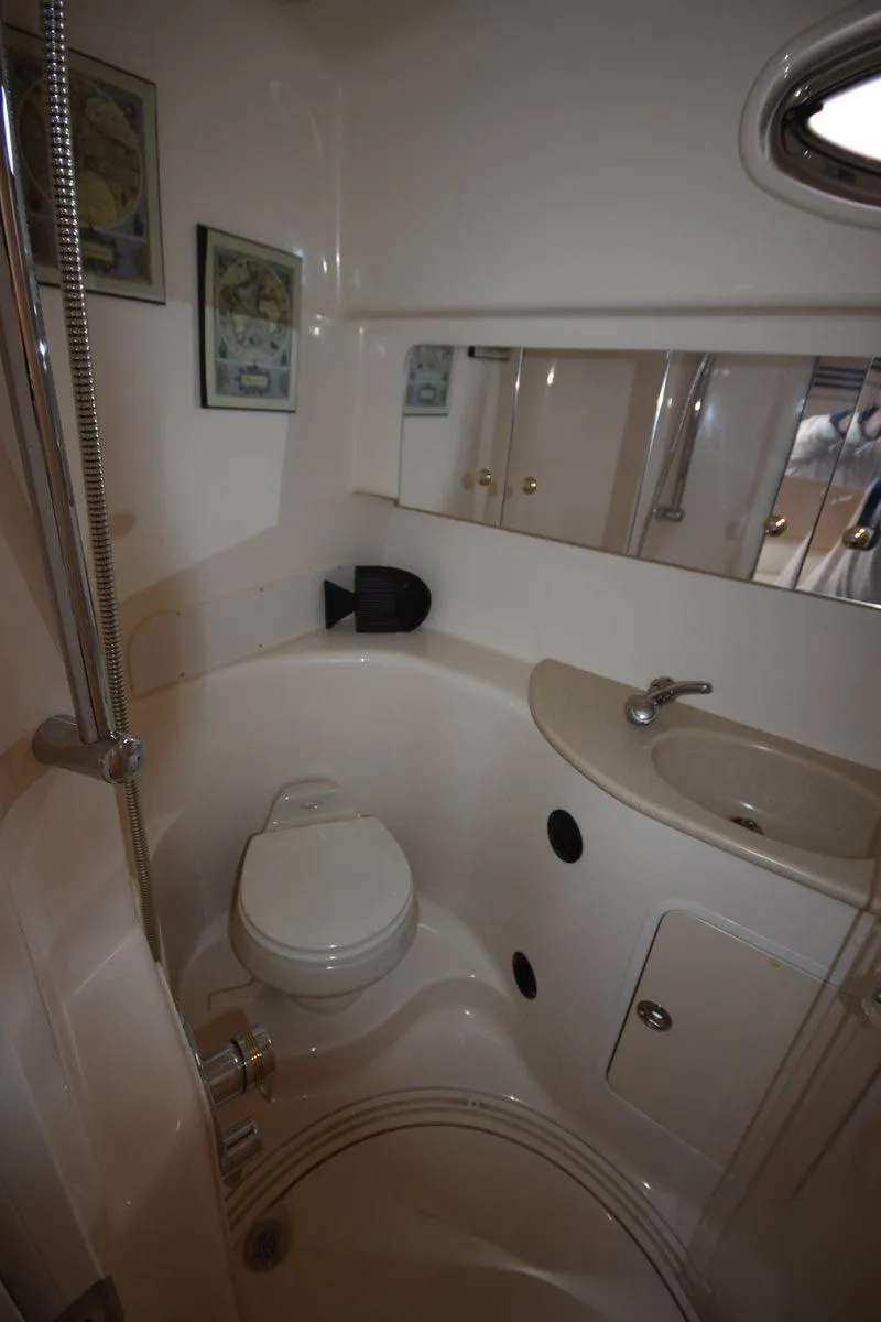 Slide: The Image of Bathroom interior of 2003 Sea Ray 360 Sundancer yacht, featuring toilet and sink. - 29