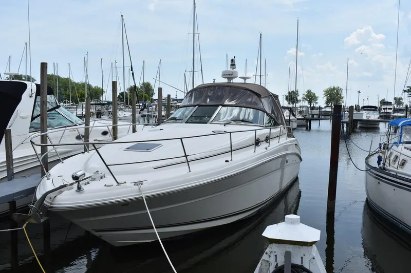 Slide: The Image of 2003 Sea Ray 360 Sundancer yacht docked at marina, surrounded by other boats. - 3