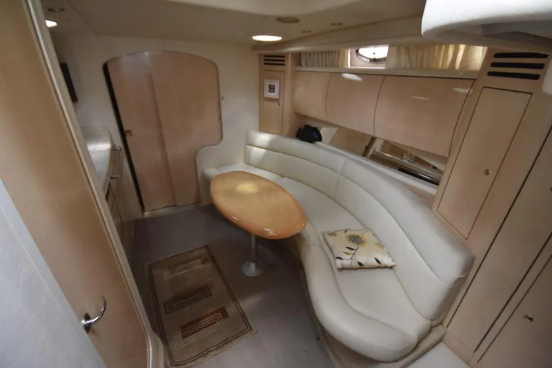 Slide: The Image of Interior of 2003 Sea Ray 360 Sundancer yacht with curved seating and wooden table. - 30