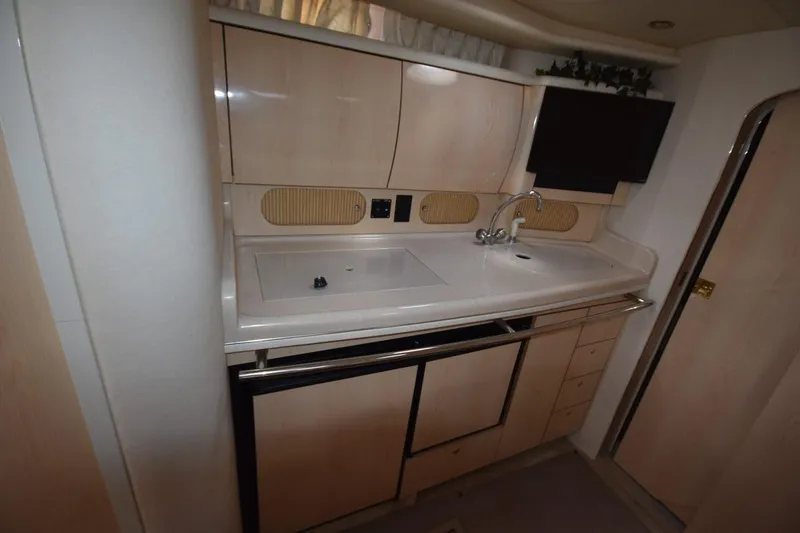 Slide: The Image of 2003 Sea Ray 360 Sundancer yacht interior kitchen with sink and cabinets. - 34