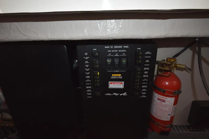 Slide: The Image of Main DC breaker panel and fire extinguisher on 2003 Sea Ray 360 Sundancer boat. - 37