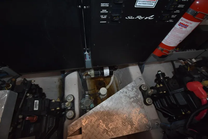 Slide: The Image of Engine compartment of a 2003 Sea Ray 360 Sundancer with control panel and fire extinguisher. - 38