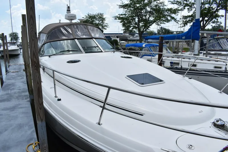 Slide: The Image of 2003 Sea Ray 360 Sundancer docked at marina, featuring sleek design and spacious deck. - 4