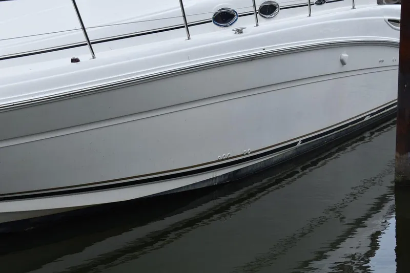 Slide: The Image of 2003 Sea Ray 360 Sundancer yacht docked in calm waters. - 5