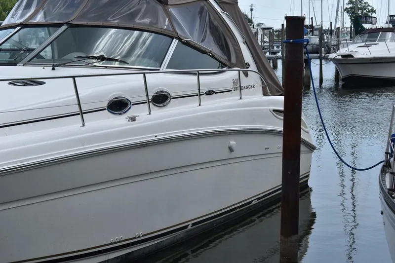 Slide: The Image of 2003 Sea Ray 360 Sundancer yacht docked in a marina, side view. - 7