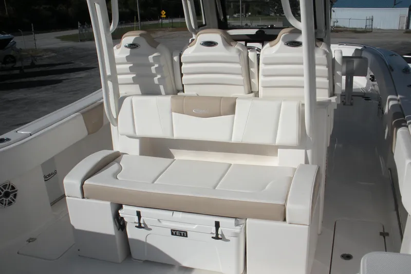 Slide: The Image of 2026 Robalo R300 Center Console boat interior with cushioned seating and Yeti cooler. - 15
