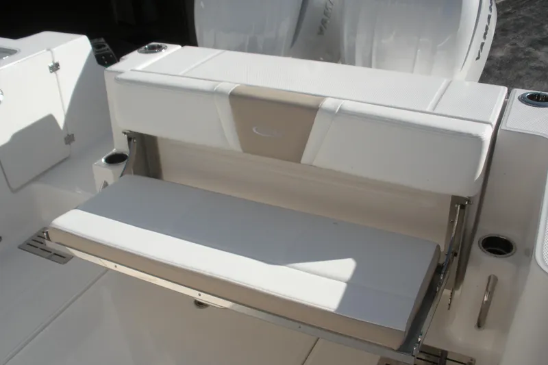 Slide: The Image of 2026 Robalo R300 Center Console boat with foldable seating and cup holders. - 18