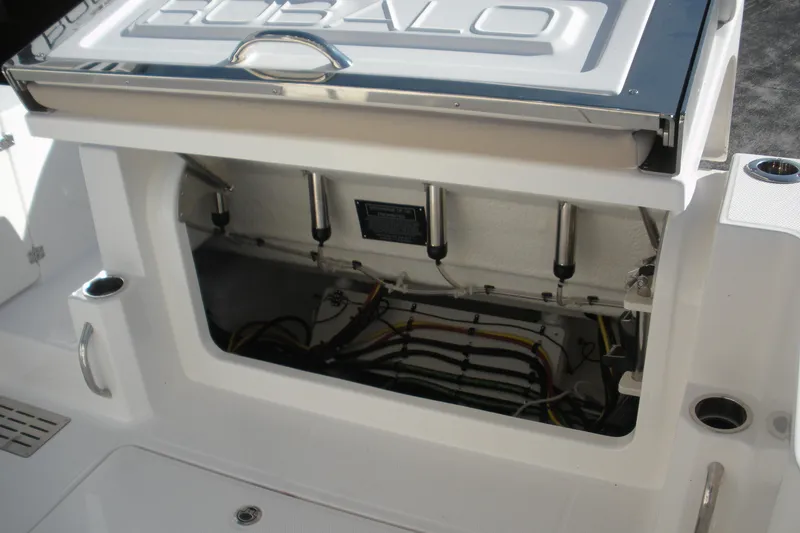 Slide: The Image of 2026 Robalo R300 Center Console boat's open storage compartment with visible wiring and hydraulic supports. - 19