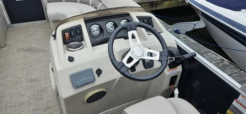 Slide: The Image of 2018 Bennington 22 SCWX boat dashboard with steering wheel and control panel. - 13