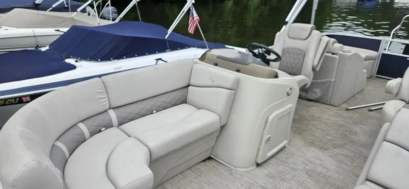 Slide: The Image of 2018 Bennington 22 SCWX pontoon boat with beige seating and steering console on a lake. - 5