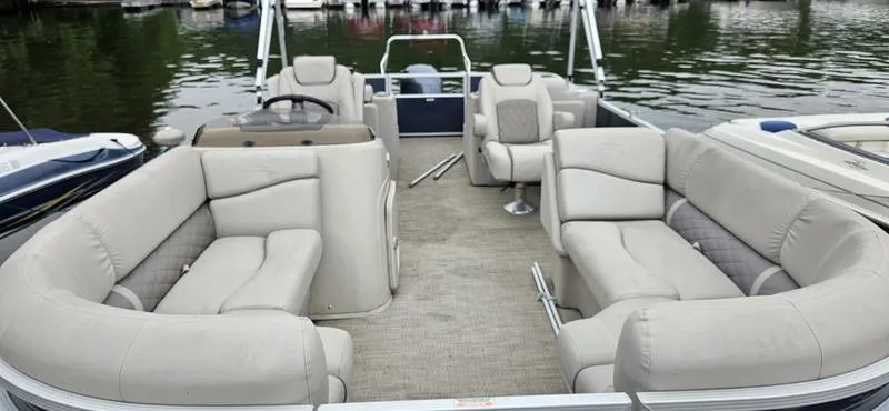 Slide: The Image of 2018 Bennington 22 SCWX pontoon boat with spacious seating on a calm lake. - 7