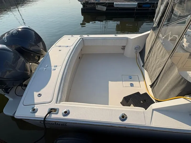 Slide: The Image of 2014 Carolina Classic 25 boat with dual outboard motors, spacious deck, and protective cover. - 13
