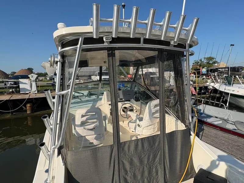 Slide: The Image of 2014 Carolina Classic 25 boat with enclosed cockpit at marina. - 17