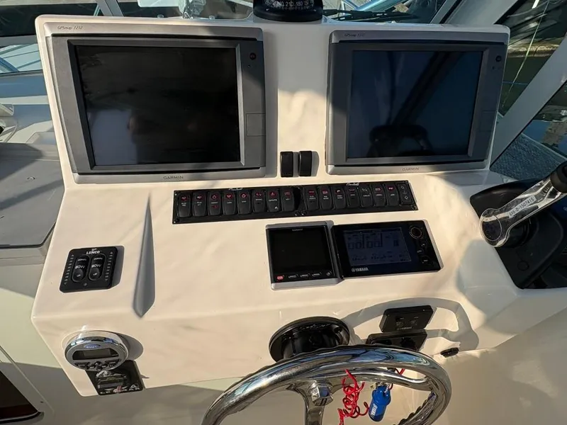 Slide: The Image of Control panel of a 2014 Carolina Classic 25 boat with Garmin displays and Yamaha controls. - 8