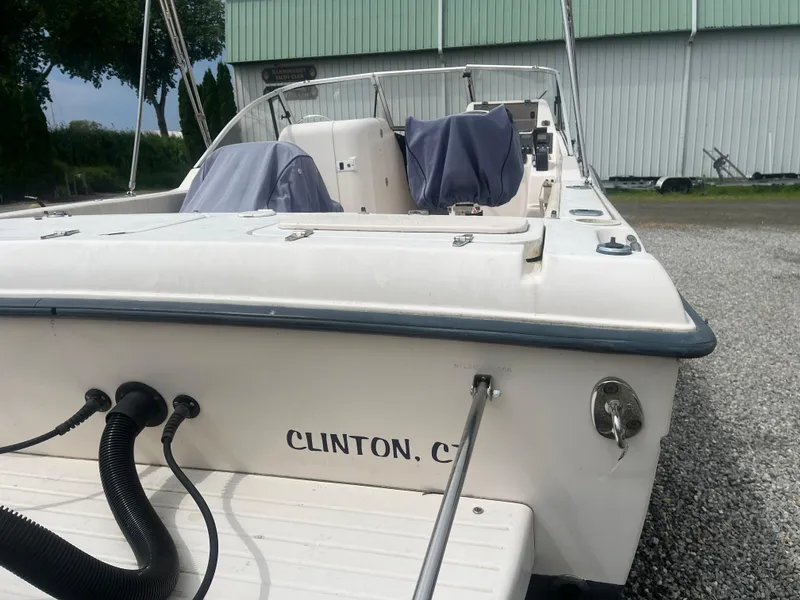 Slide: The Image of 2006 Grady-White Tournament 225 boat docked, rear view, with covered seats. - 2