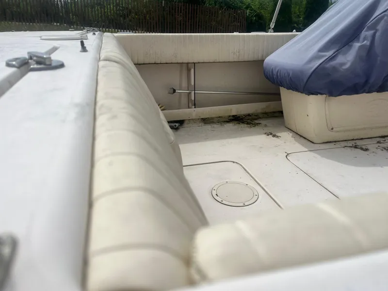 Slide: The Image of 2006 Grady-White Tournament 225 boat interior with covered seating and clean deck. - 3