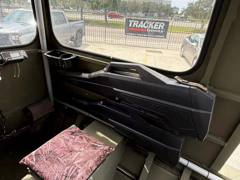 Slide: The Image of Interior of 1995 Custom Aluminum 2073 Cabin with gun case and camo cushion. - 10