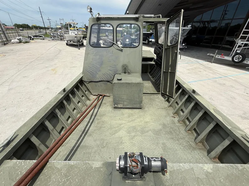 Slide: The Image of 1995 Custom Aluminum 2073 Cabin boat with open deck and visible cabin interior. - 12