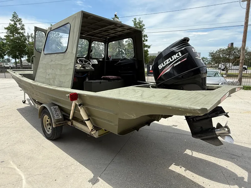 Slide: The Image of Custom Aluminum 2073 Cabin boat, 1995 model, with Suzuki outboard motor on trailer. - 4