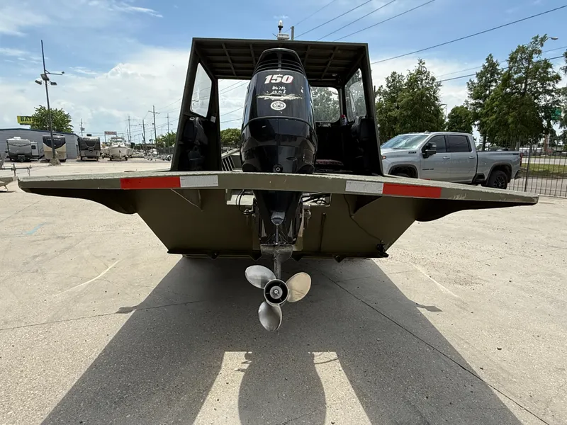 Slide: The Image of Custom Aluminum 2073 Cabin boat, 1995 model, with outboard motor, parked outdoors. - 5