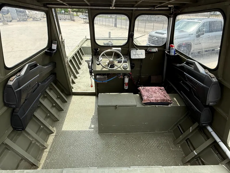 Slide: The Image of Interior of a 1995 Custom Aluminum 2073 Cabin boat with steering wheel and equipment. - 7