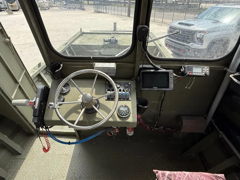 Slide: The Image of Interior of 1995 Custom Aluminum 2073 Cabin with steering wheel and navigation equipment. - 8